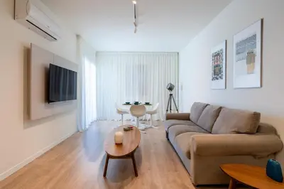 a living room with a couch and a table at Stylish Central Apartment • City Views • Prime Location • Parking in Nicosia