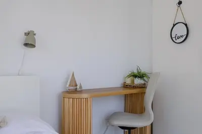 a bedroom with a desk and a chair at Endless Summer Beach House in Pervolia