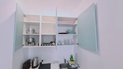 a kitchen with white cabinets and a sink at STAY Napa Oasis Studio in Ayia Napa