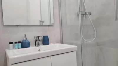 a white bathroom with a sink and a shower at STAY Napa Oasis Studio in Ayia Napa
