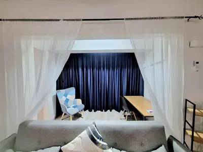 a bedroom with a couch and a desk and a table at Abstract by the Sea in Larnaka