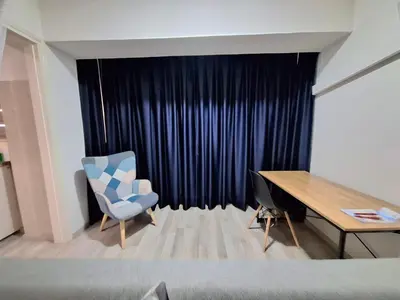 a bedroom with a desk and a chair and a table at Abstract by the Sea in Larnaka