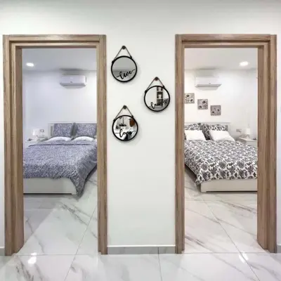 a bedroom with two mirrors and a bed in it at Mandy's apartment in Larnaka