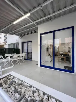 a living room with a large window and a room with rocks at Mandy's apartment in Larnaka