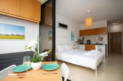 a room with a bed and a table with a dining room at Palmove Makenzy Ria Studio in Larnaka