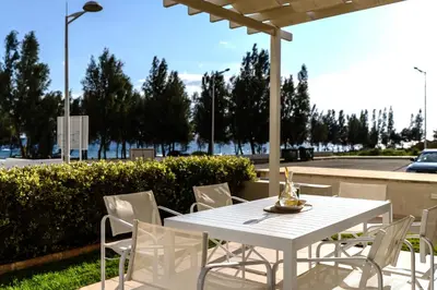 a white table and chairs on a patio at Niki Seaview Villa DPS27 in Protaras