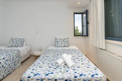 a bedroom with two beds and a window at Niki Seaview Villa DPS27 in Protaras