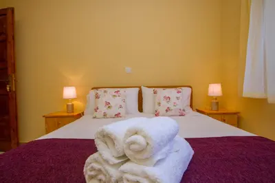 a bedroom with a bed with towels on it at VILLa PERSEPHONE in Platres