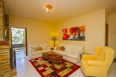 a living room with two couches and a table at VILLa PERSEPHONE in Platres
