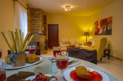 a living room with a table with food on it at VILLa PERSEPHONE in Platres
