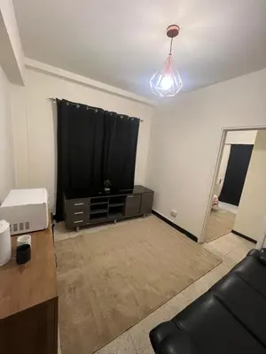 a living room with a tv and a couch at Enjoy a cozy room in the heart of the capital in Nicosia