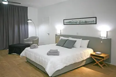 a bedroom with a large bed with towels on it at Corina Suites & Apartments in Limassol