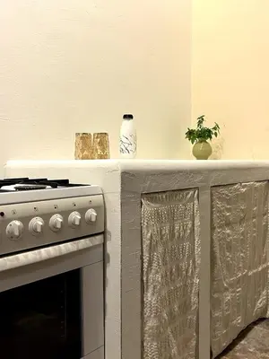 a kitchen with a stove and a counter top withartifacts at Archontiko Papadopoulou in Mosphiloti