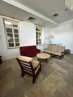 a living room with a couch and a table at Archontiko Papadopoulou in Mosphiloti