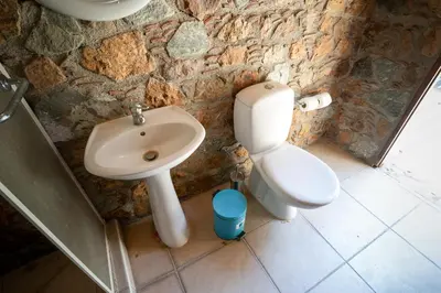 a bathroom with a sink and a toilet at Aέναη in Pyrga