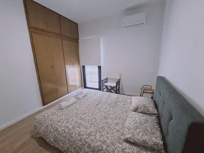 a bedroom with a bed with a large headboard at Limassolian vibe house in Limassol