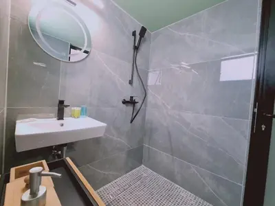 a bathroom with a shower and a sink and a mirror at Limassolian vibe house in Limassol