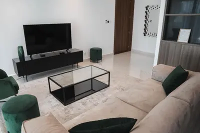 a living room with a couch and a tv at 360 Luxury One Bedroom Suite in Nicosia