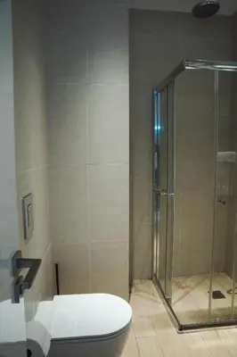 a bathroom with a toilet and a glass shower at 360 Luxury One Bedroom Suite in Nicosia