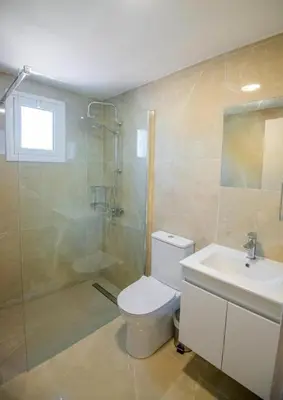 a bathroom with a toilet and a shower and a sink at Marisa Napa Suites Ayia Napa in Ayia Napa