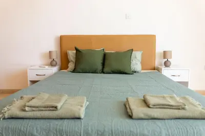 a bed with two towels on top of it at Stunning apartment with sea view in Larnaka