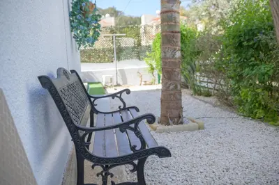 a black bench sitting next to a building at Cavo Greco Oasis in Protaras