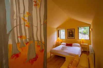 a bedroom with a bed and a tree mural at Amazing Villa in Pano Platres Cyprus in Kato Platres