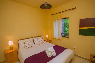 a bedroom with a bed with shoes on it at Amazing Villa in Pano Platres Cyprus in Kato Platres