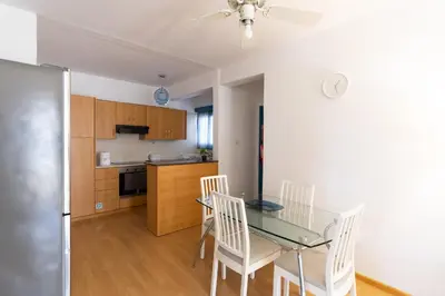 a kitchen and dining room with a glass table and chairs at Downtown apartment - Ayia Napa in Ayia Napa