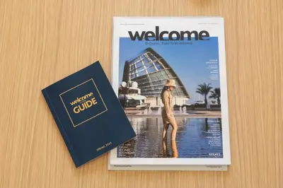 a magazine and a book sitting on a table at Downtown apartment - Ayia Napa in Ayia Napa