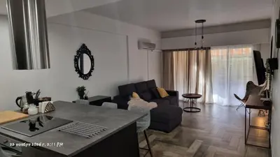 a living room with a couch and a table at Deana beach in Limassol