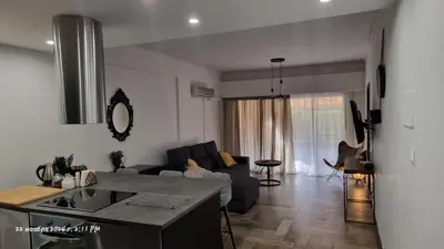 a kitchen and living room with a couch and a table at Deana beach in Limassol