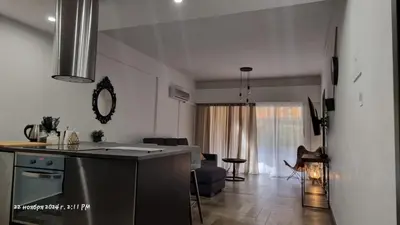 a kitchen and a living room with a counter top at Deana beach in Limassol