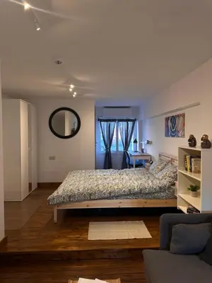 a bedroom with a large bed and a mirror at Cozzi Deluxe Studio in Voroklini