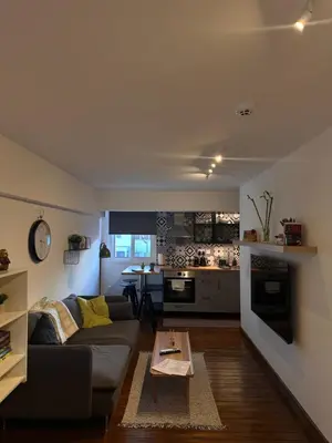 a living room with a couch and a table at Cozzi Deluxe Studio in Voroklini