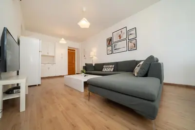 a living room with a couch and a tv at 1 bedroom flat in city center in Nicosia