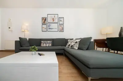 a living room with a couch and a table at 1 bedroom flat in city center in Nicosia