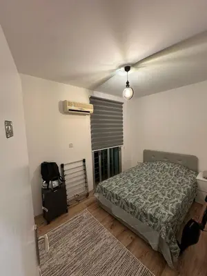 a bedroom with a bed and a window at 5 minutes to the sea in Kyrenia new port in Meniko