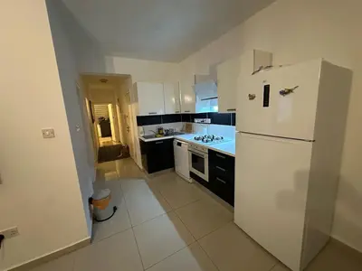 a kitchen with a white refrigerator and a stove at 5 minutes to the sea in Kyrenia new port in Meniko