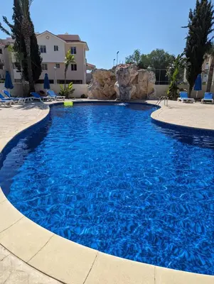 a large pool with blue water in a resort at Pyla Village Resort E108 in Pyla