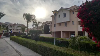 a building with the sun setting in the background at Pyla Village Resort E108 in Pyla