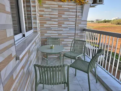 a patio with two chairs and a table on a balcony at Stay With Oleg 102A in Paralimni