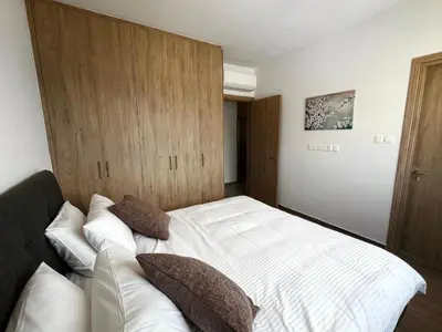 a bedroom with a white bed with pillows on it at Rachel 401 in Larnaka