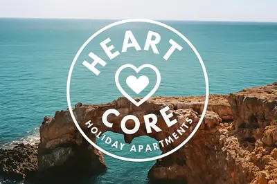 a sign that says heart core on a cliff next to the ocean at HeartCore Holiday Apartments in Ayia Napa