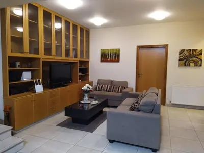 a living room with a couch and a tv at The Tower Penthouse in Strovolos