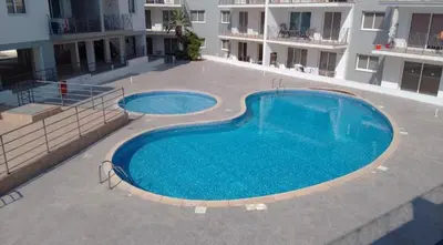a large swimming pool in the middle of a building at Beautiful 2 Bed Ground Floor Apartment With Pool in Paralimni