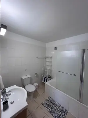 a bathroom with a toilet and a sink and a shower at Beautiful 2 Bed Ground Floor Apartment With Pool in Paralimni