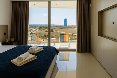 a hotel room with a bed with towels on it at New Luxury 2BR Seaview Apt, Sun City, Pool and Beach in Ayia Napa