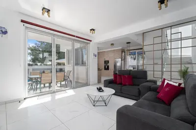 a living room with a couch and a table at Levanda Hills Escape in Protaras in Paralimni