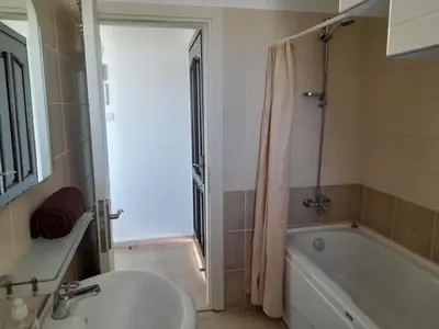 a bathroom with a tub and a sink and a toilet at Crystal Bay Marina B3-5 in Troulli